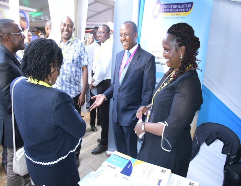 Registrar of Political Parties (right) with high-level delegates including former Registrar of Political Parties, Lucy Ndung’u (left) at the ORPP stand during the Devolution Conference 2023 at Eldoret